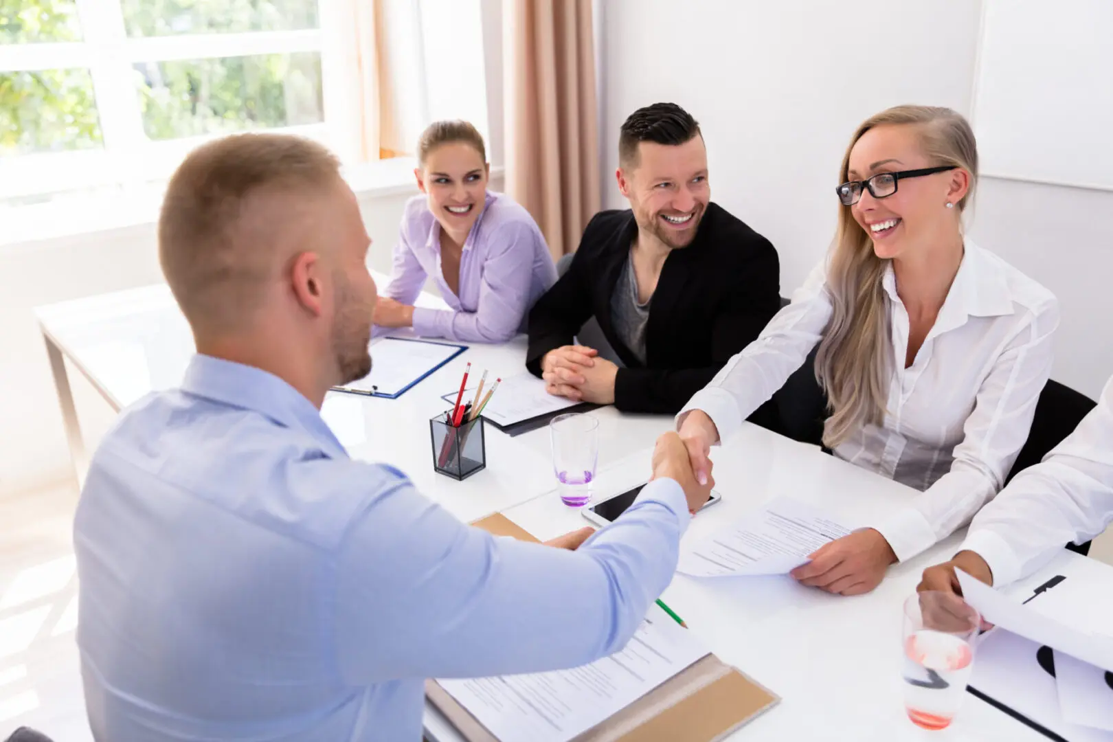 A group of people sitting around a table.