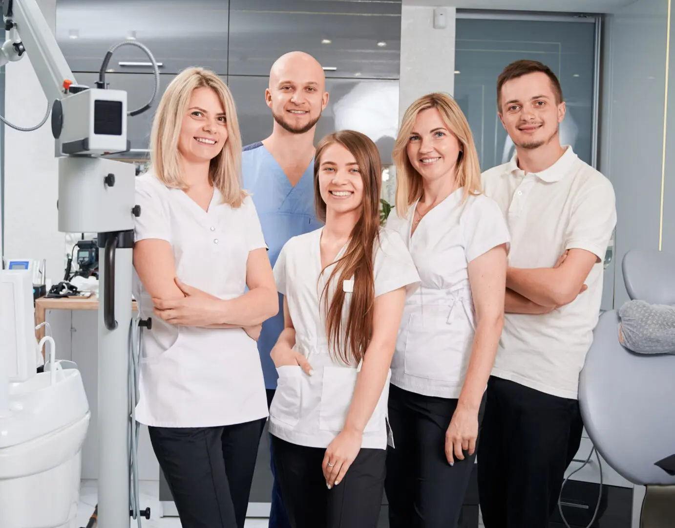 A group of people standing in front of an eye exam room.